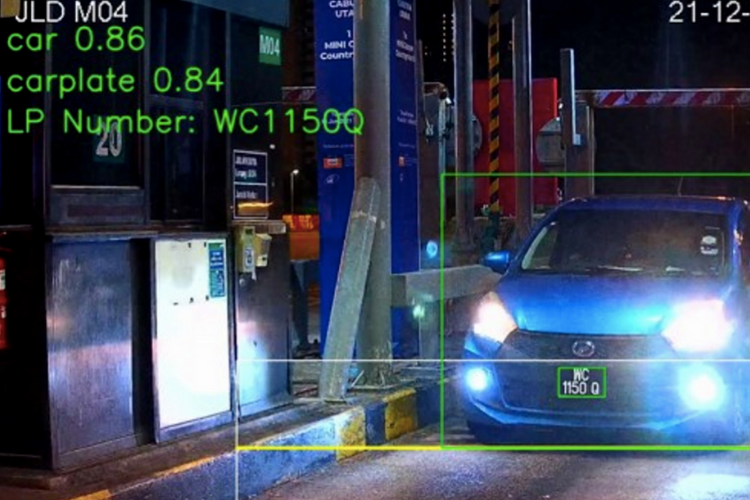 automatic number plate recognition on blue car going through toll booth